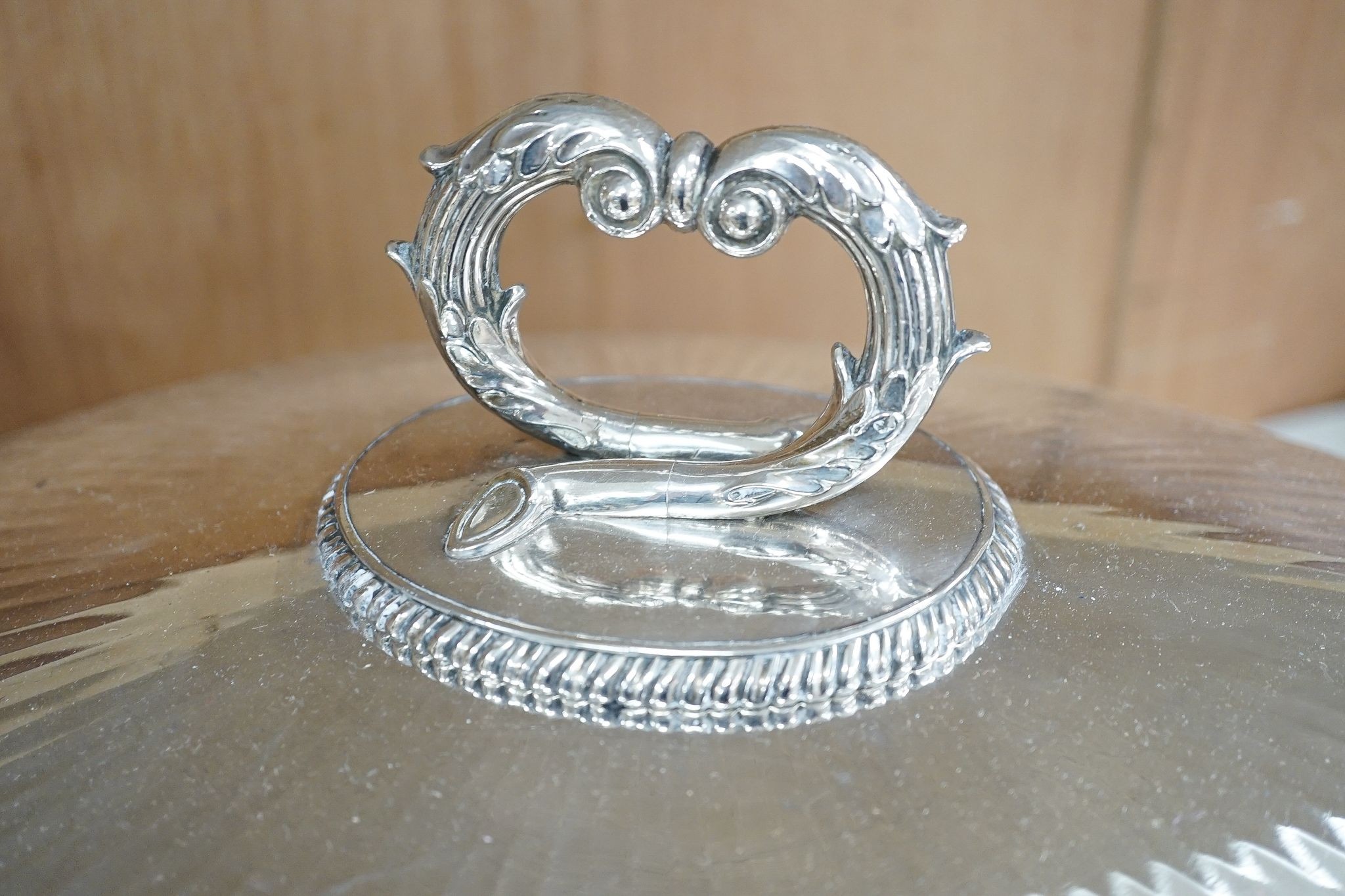 Two Victorian electroplate meat domes, and a hot water meat dish, 62 cms wide including handles.